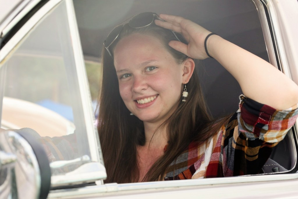 A model pushes up her sunglasses while enjoying her ride