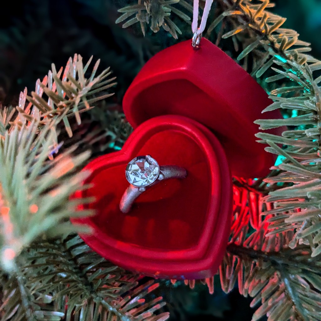 Engagement ring box ornament hanging on a Christmas tree